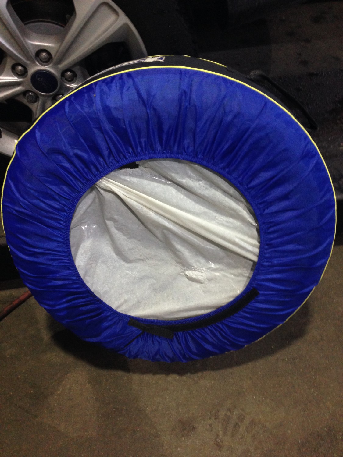 Four tires in tire covers ready for storage