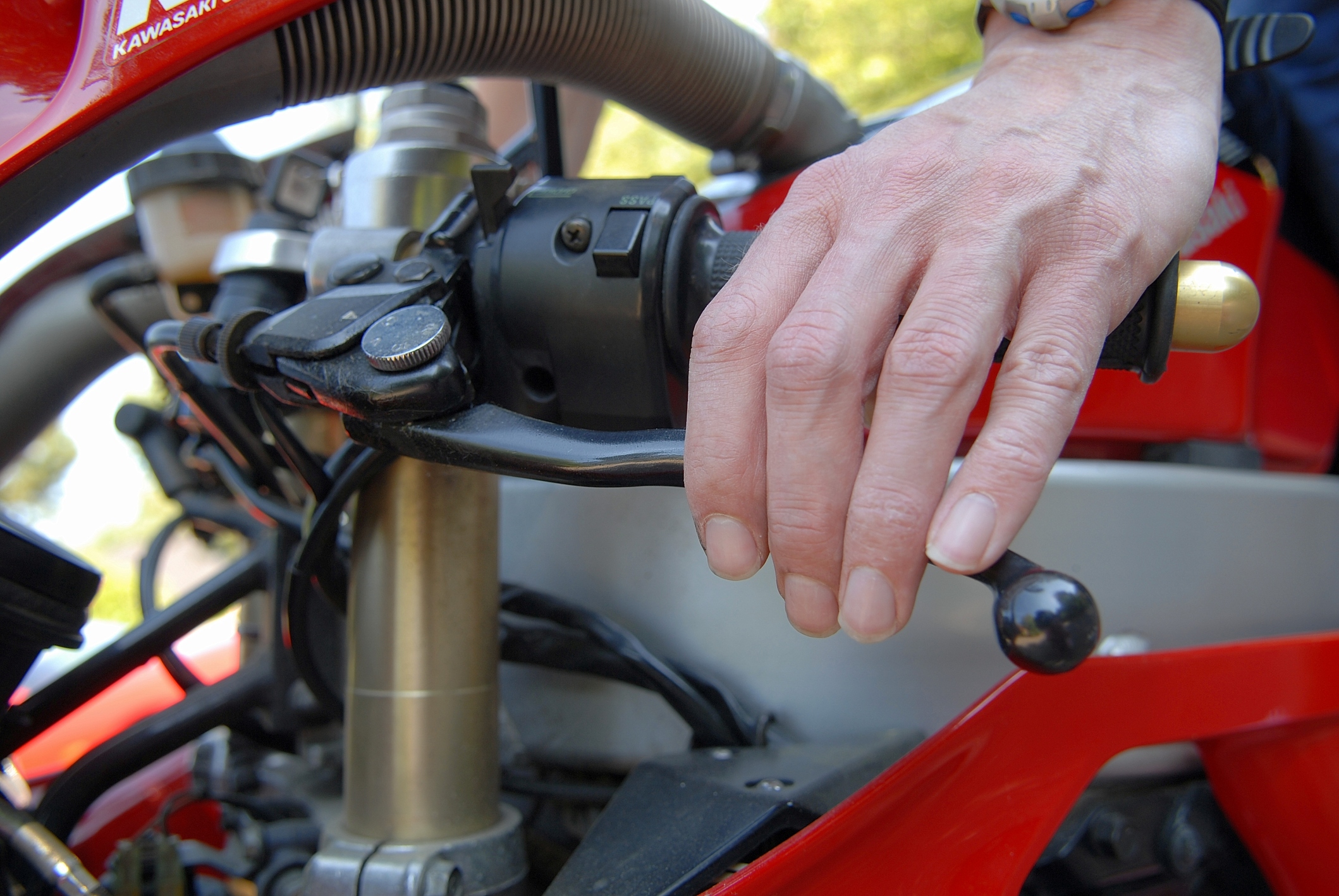 Close-up of man testing motorbike brakes