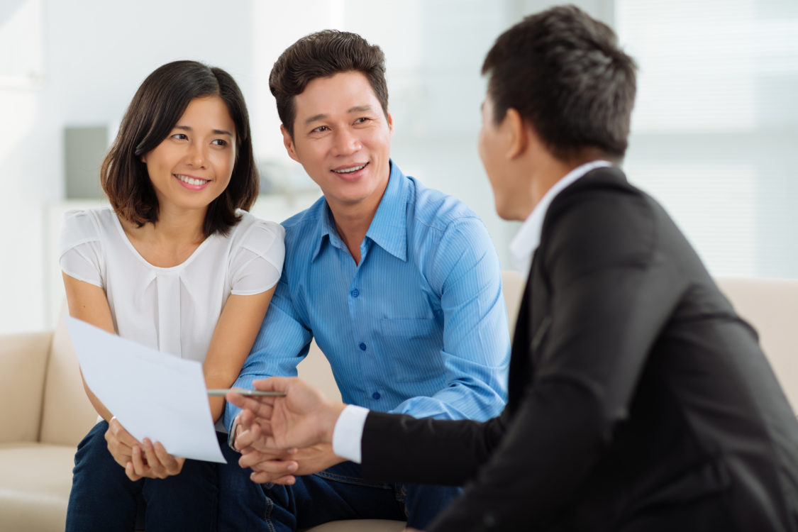 Middle-aged Asian couple at financial planning consultation
