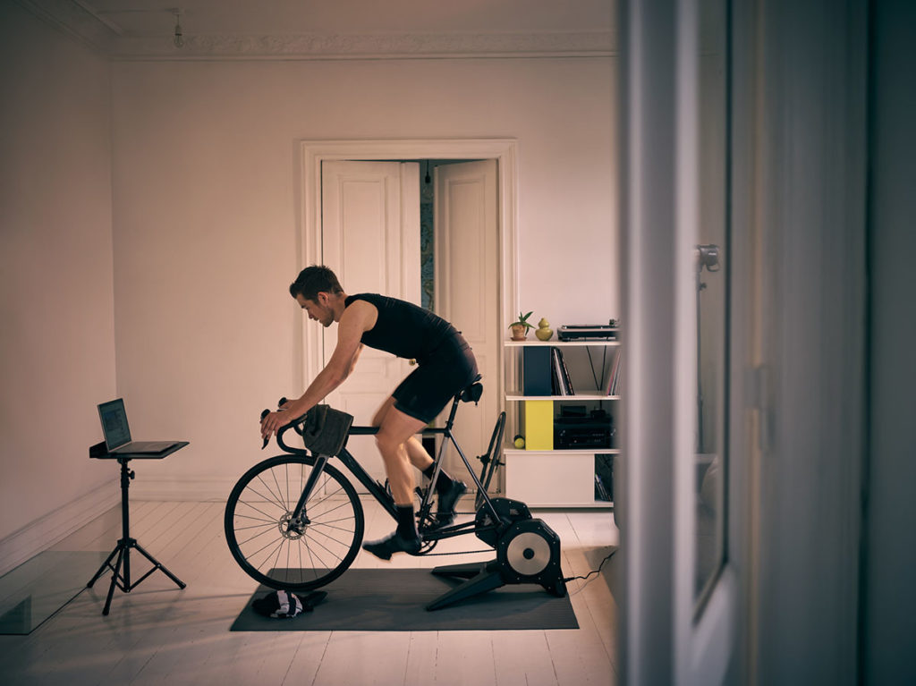 Image d'un jeune homme travaillant sur un vélo d'exercice à la maison