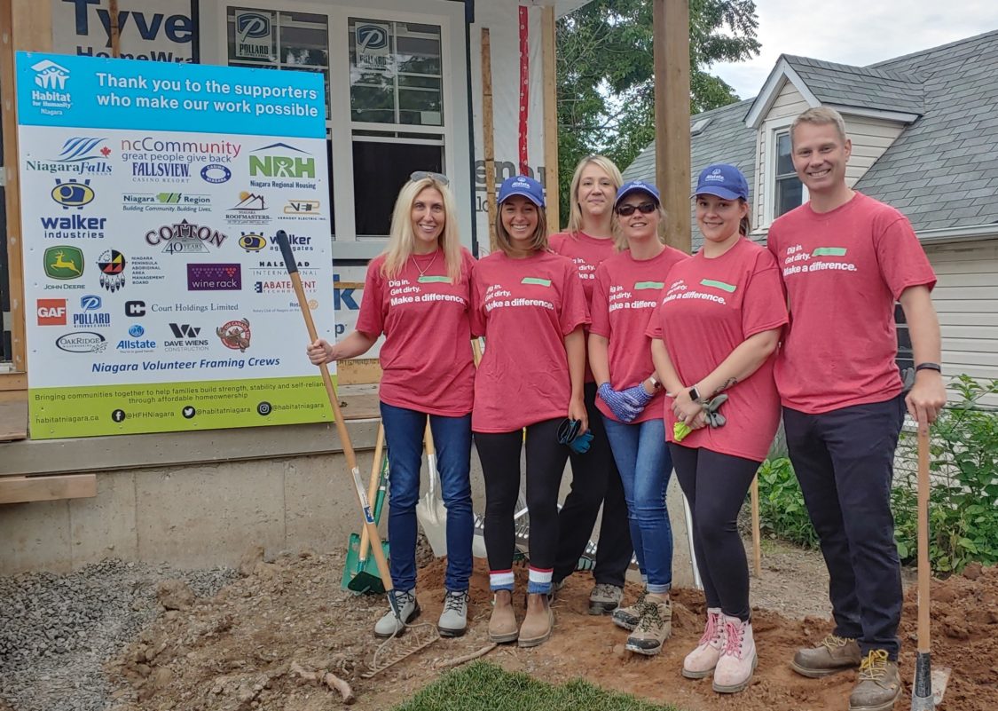 Image of Allstate Agents in pink Habitat for Humanity shirts posing for a photo