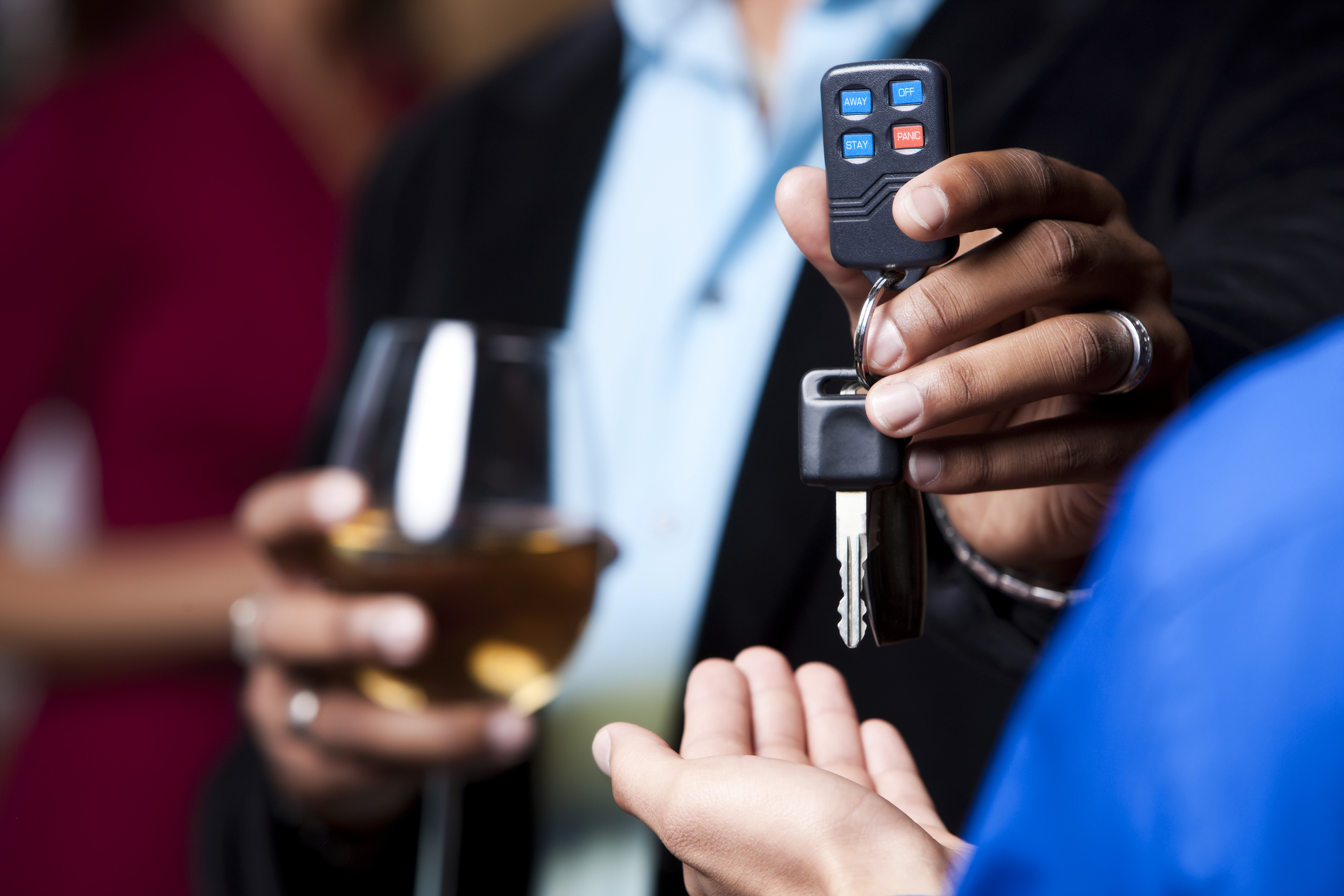 Close-up of a guy handing over the car keys to his friend