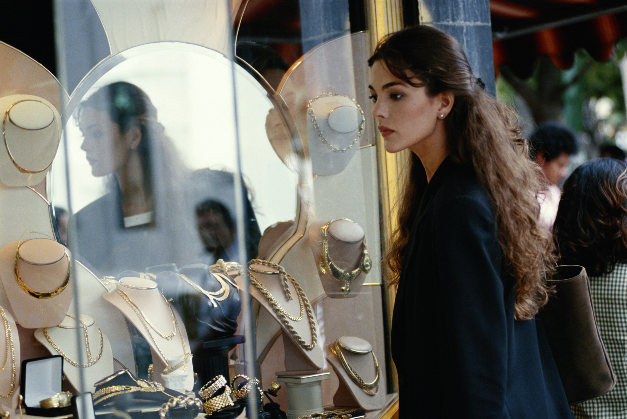Woman looking at jewellery through a window