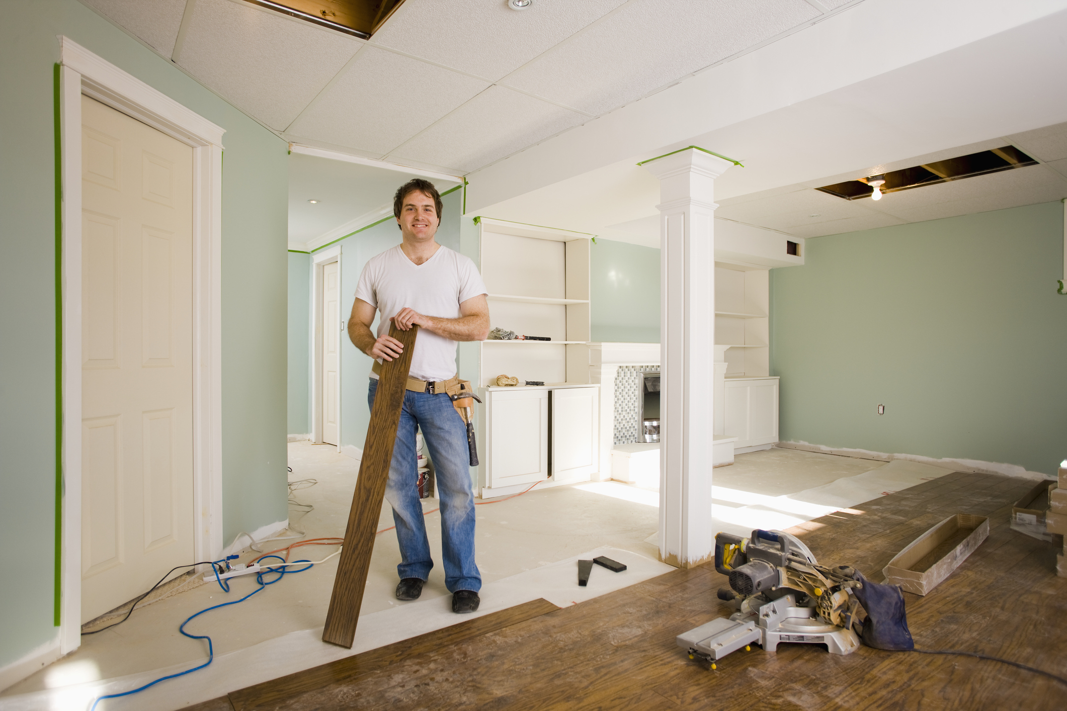 Photo of a man installing hardwood floors