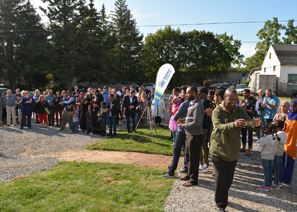 A crowd gets together for a Habitat for Humanity Canada Home Dedication event