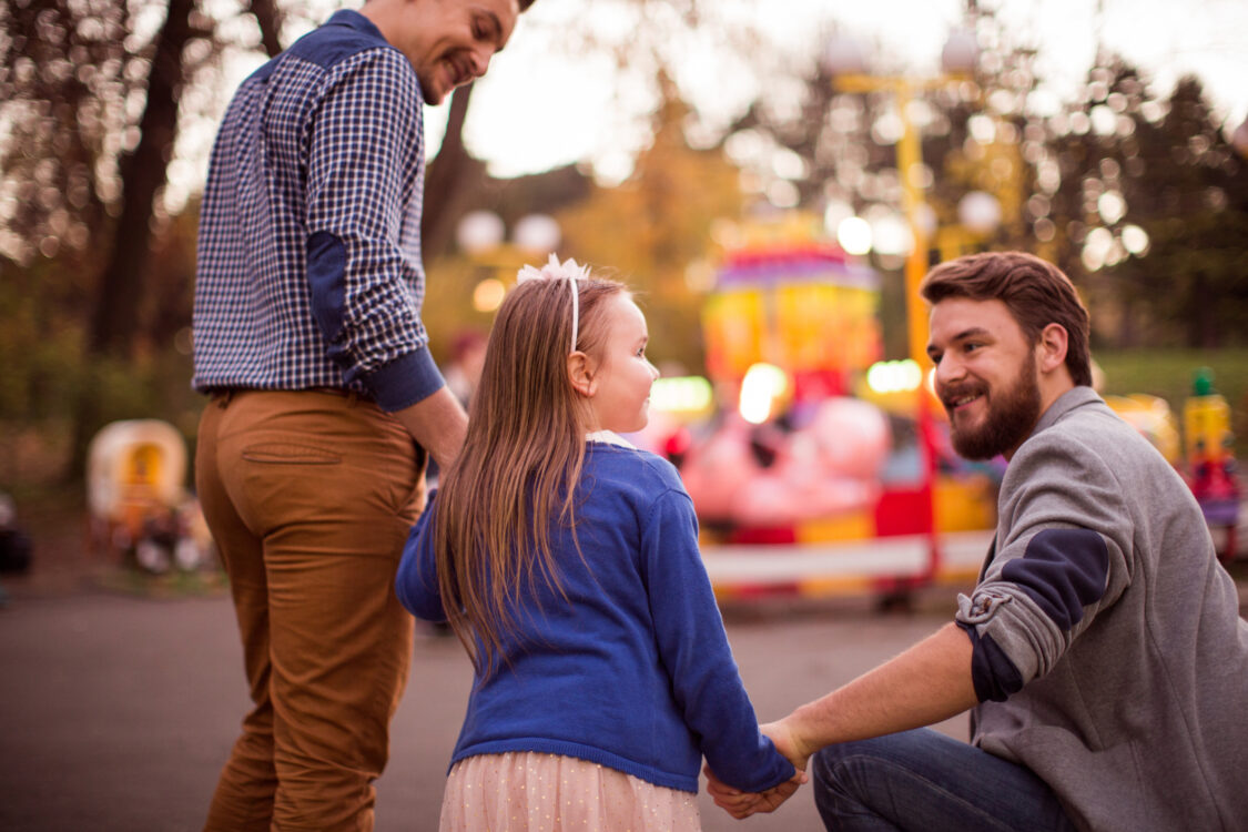 Gay Parents with daughter at an amusement park