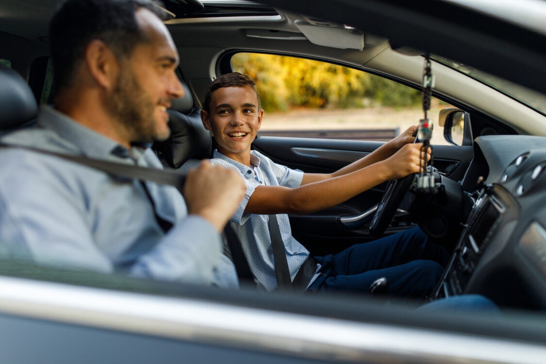 man teaching his teenager how to drive 
