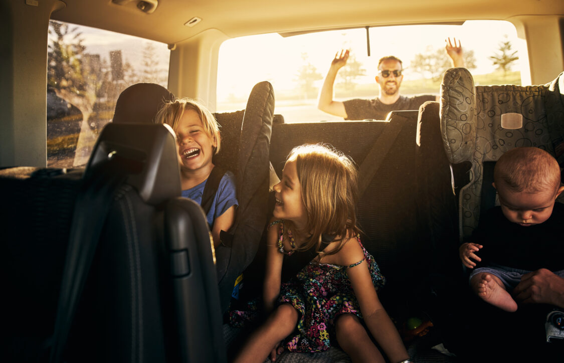 photo of adorable little children sitting in a car