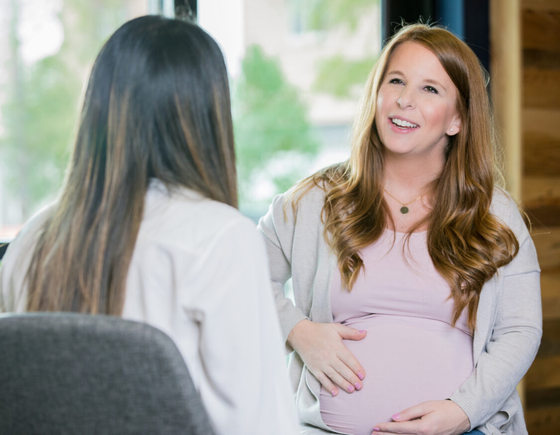 Expectant mother meeting with an insurance agent