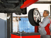 Image of a tire being replaced by a mechanic at an auto body shop