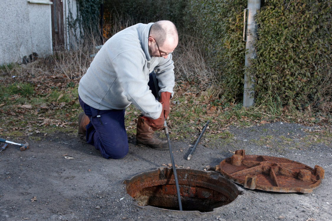 Man clearing the drains
